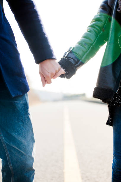 istock closeup of young affectionate couple holding hands 907911338