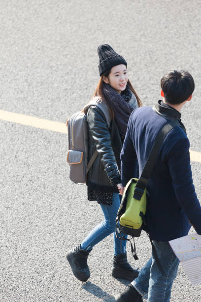 istock elevated view of young affectionate couple with backpack travelling 907911574