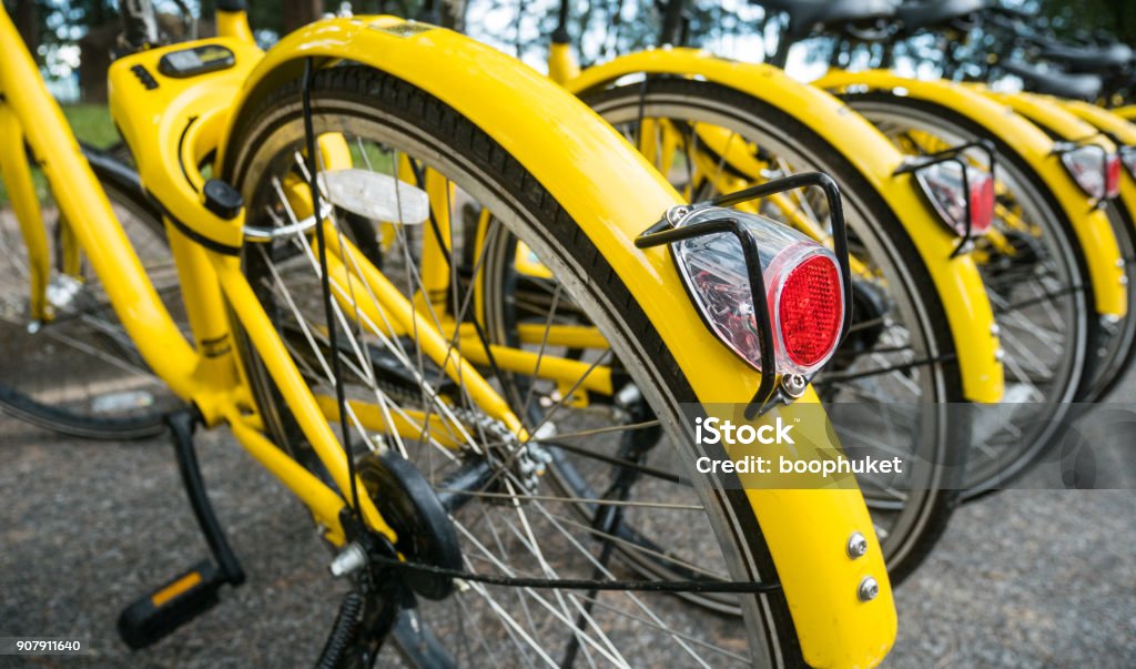 Close up Bicycle tail light on group of yellow vintage bike parking in the Park to service the touristi n bike sharing concept Bicycle Sharing System Stock Photo