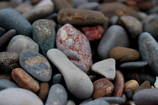 istock Background of large grey pebbles on beach 907913174