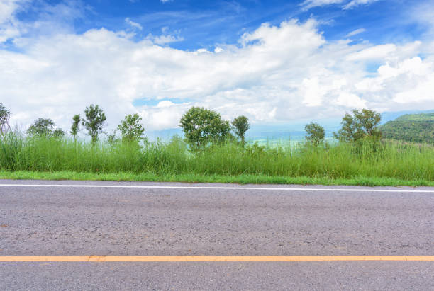 istock Asphalt road and mountains landscape under morning sky with clouds 907916592