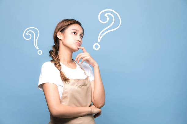 istock young housewife with question marks. 907918798