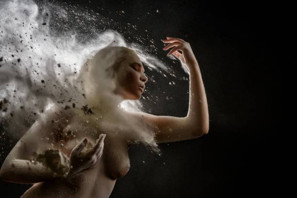 istock Girl topless in a cloud of white dust studio portrait 907919582