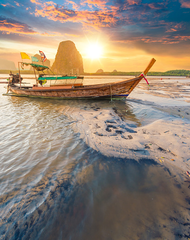 Beautiful sunset at tropical sea with long tail boat in south thailand