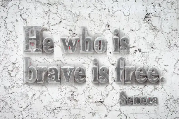 He who is brave is free - ancient Roman philosopher Seneca quote mounted on white marble wall