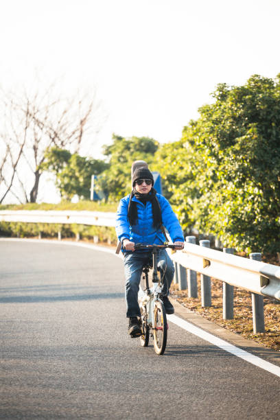 istock man on bicycle with guitar riding on mountain highway 907925666