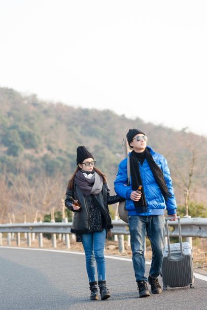 istock man carrying guitar travelling with his girlfriend 907926502
