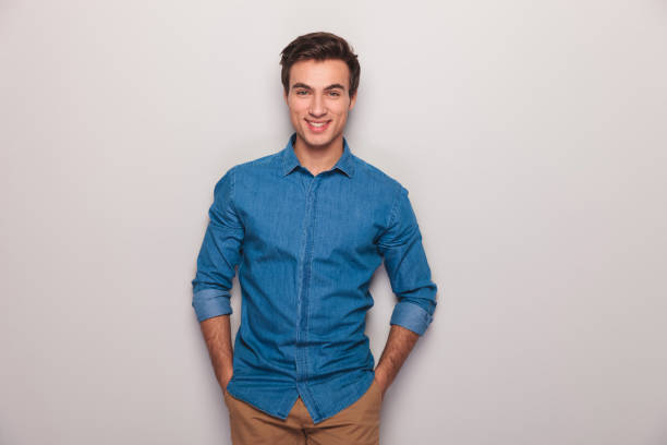 istock happy casual man with hands in pockets smiling 907928010