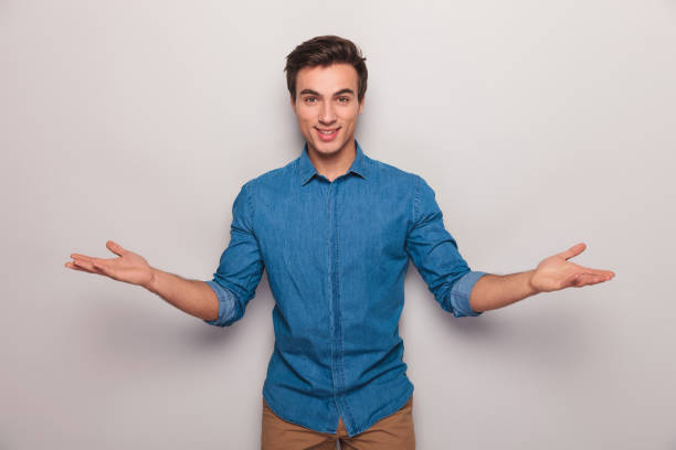 istock smiling young casual man welcoming 907928086
