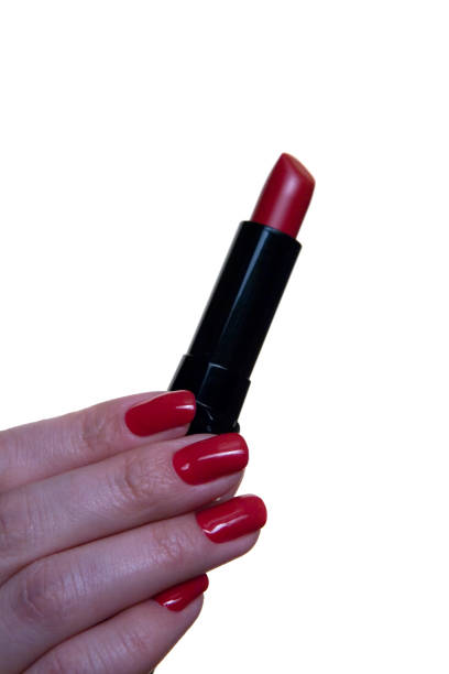 istock Red lipstick in a beautiful female hand. 907928134