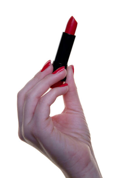istock Red lipstick in a beautiful female hand. 907928142