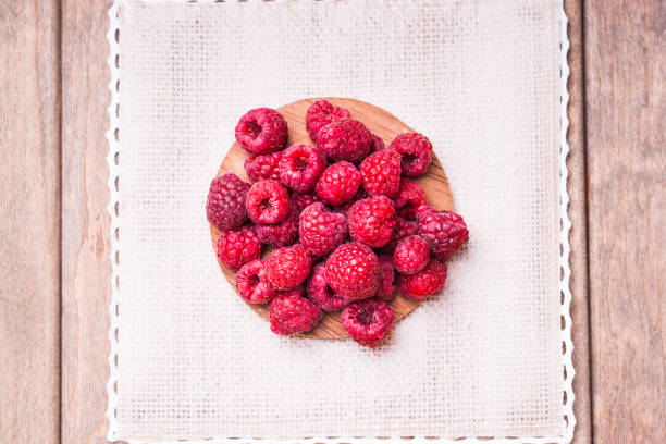 istock Raspberries on a wooden cutting board 907929862