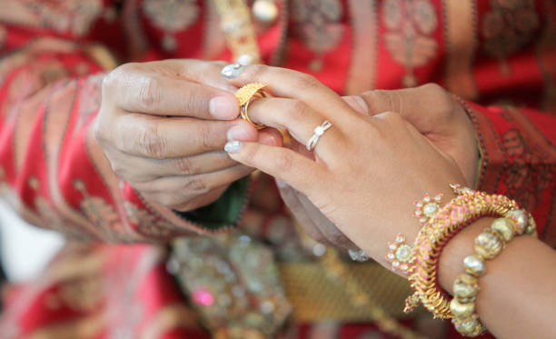 istock Wearing dress Thai wedding a Rings. 907931088