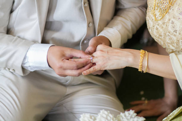 istock Wearing dress Thai wedding a Rings. 907931212
