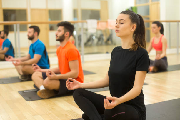 istock Group of young people meditating 907931242