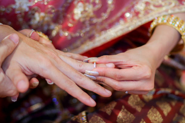 istock Wearing dress Thai wedding a Rings. 907931812