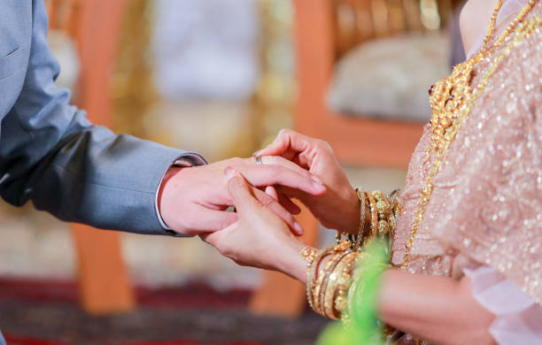 istock Wearing dress Thai wedding a Rings. 907932006