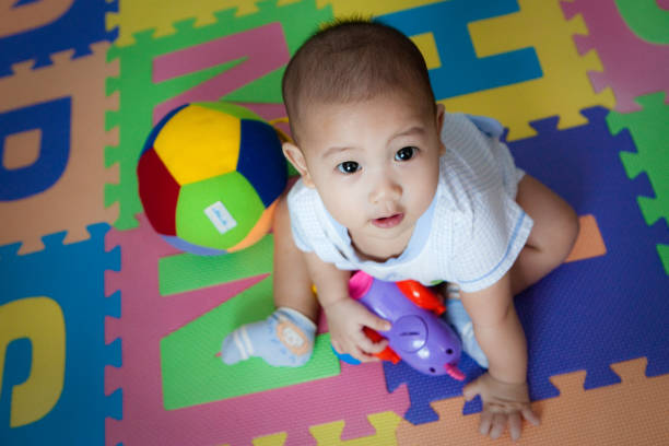 Cute small boy playing with plastic toy on the table