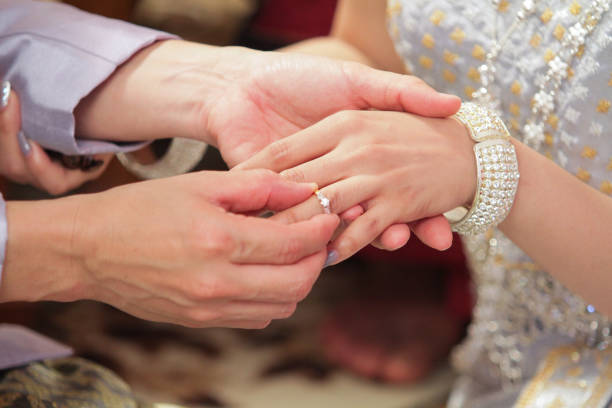 istock Wearing dress Thai wedding a Rings. 907932428