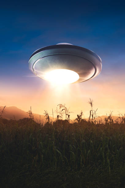 istock UFO with abduction beam flying in the sky 907932430
