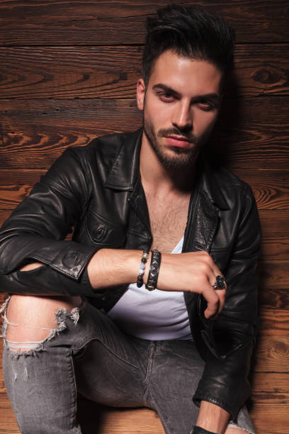 istock seated fashion man with elbow on knee 907933242