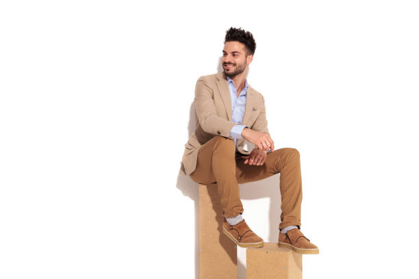 istock laughing young businessman is sitting on wood boxes 907933532