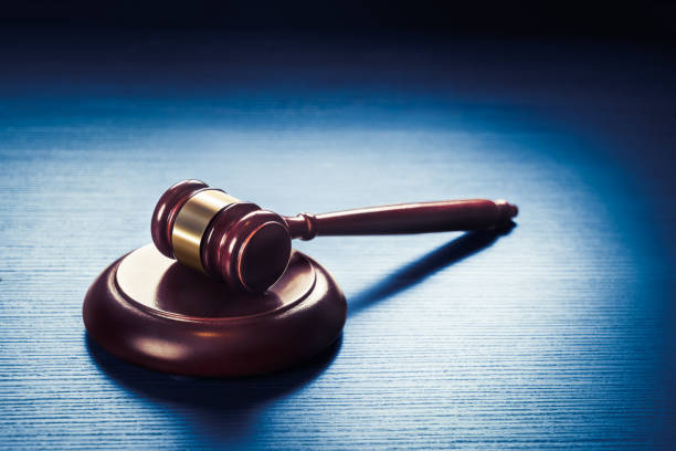 istock judge gavel on a blue wooden background 907933902