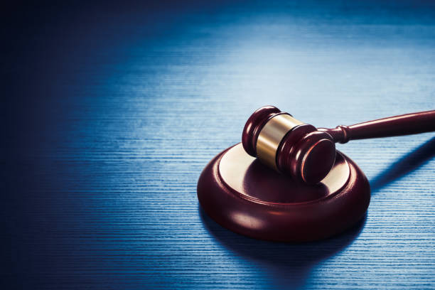 judge gavel on a blue wooden background - legal system imagens e fotografias de stock