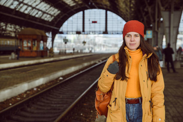 istock woman walk by railway station 907934330