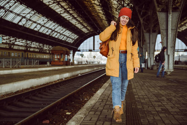 istock woman walk by railway station 907934376