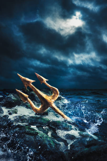 High contrast image of Poseidon's trident at sea High contrast imgae of Poseidon's trident resting on some rocks by the sea neptune fork stock pictures, royalty-free photos & images
