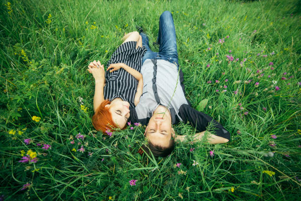 istock couple lie on the grass 907934768
