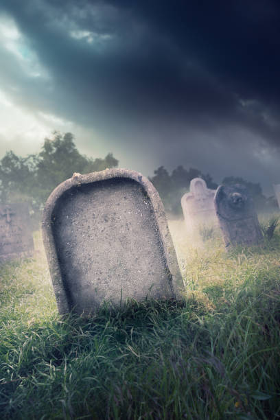 istock gravestone with fog and dramatic lighting 907936154