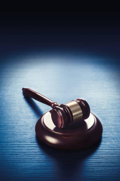 judge gavel on a blue wooden background stock photo