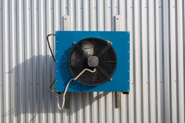 istock Front view of the small blue industrial cooling unit installed on the gray metallic wall 907936588