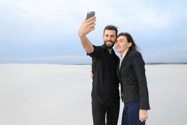 istock boyfriend and girlfriend testing front-camera in new smar 907936898