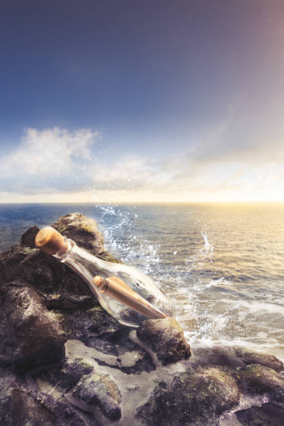 istock glass bottle with message at sea 907938886