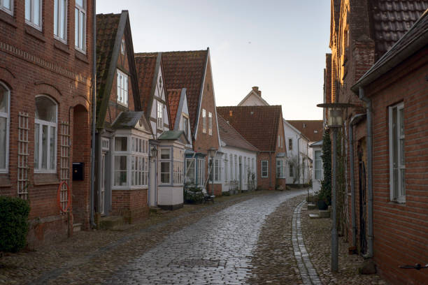 istock Old part of town with a cobblestone road 907938940