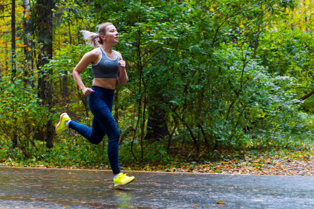 istock Woman running in the autumn park 907939780