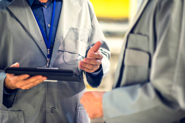 istock Close-up of two engineers talking and looking at digital tablet 907940018