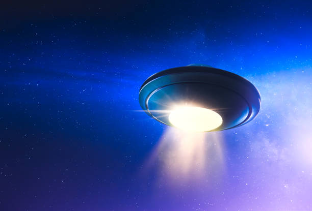 istock UFO with abduction beam flying in the sky 907940448