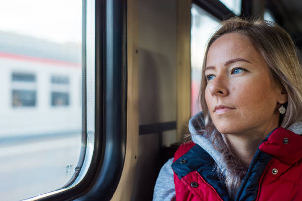 istock Young woman traveling by train 907940750
