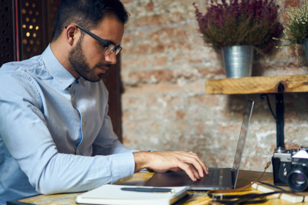 istock Skilled male copywriter concentrated on completing working task making distance job in cozy cafe interior with wifi access, pensive young businessman checking financial reports on laptop computer 907942352