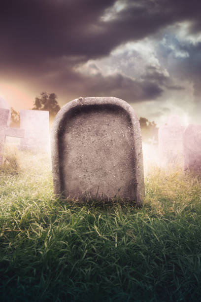 istock gravestone with fog and dramatic lighting 907942740