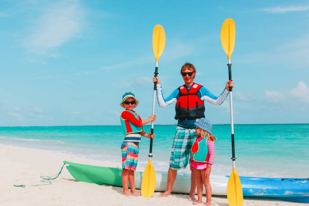 istock father with little son and daugther kayaking at beach 907942962