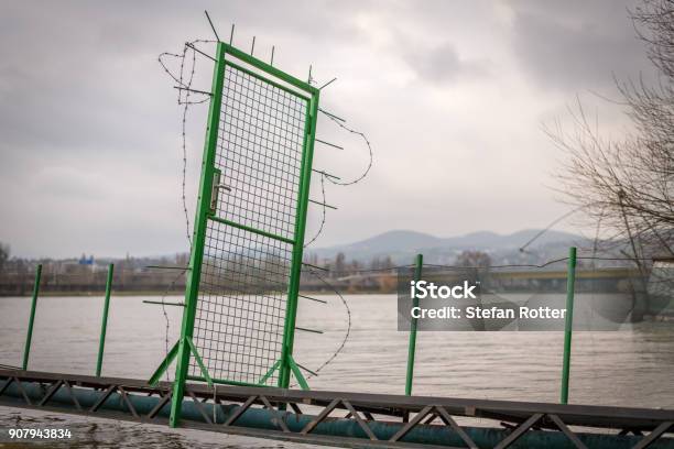 Green Door With Barbed Wire On A Narrow Bridge Leading To A House Boat Stock Photo - Download Image Now