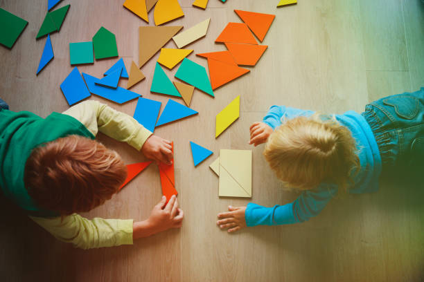 istock kids playing with puzzle, learn shapes, education concept 907944178