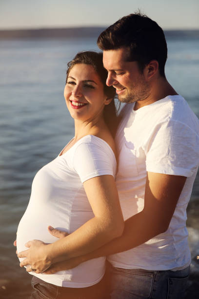 istock Future parents enjoying in a beautiful sunny day 907944192