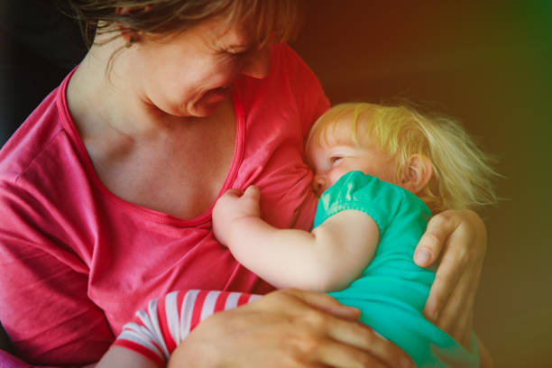 istock mother breastfeeding little baby daughter 907944352