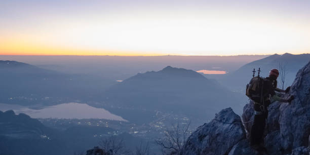 istock Alpinist moving up on mountain range during twilight 907945384